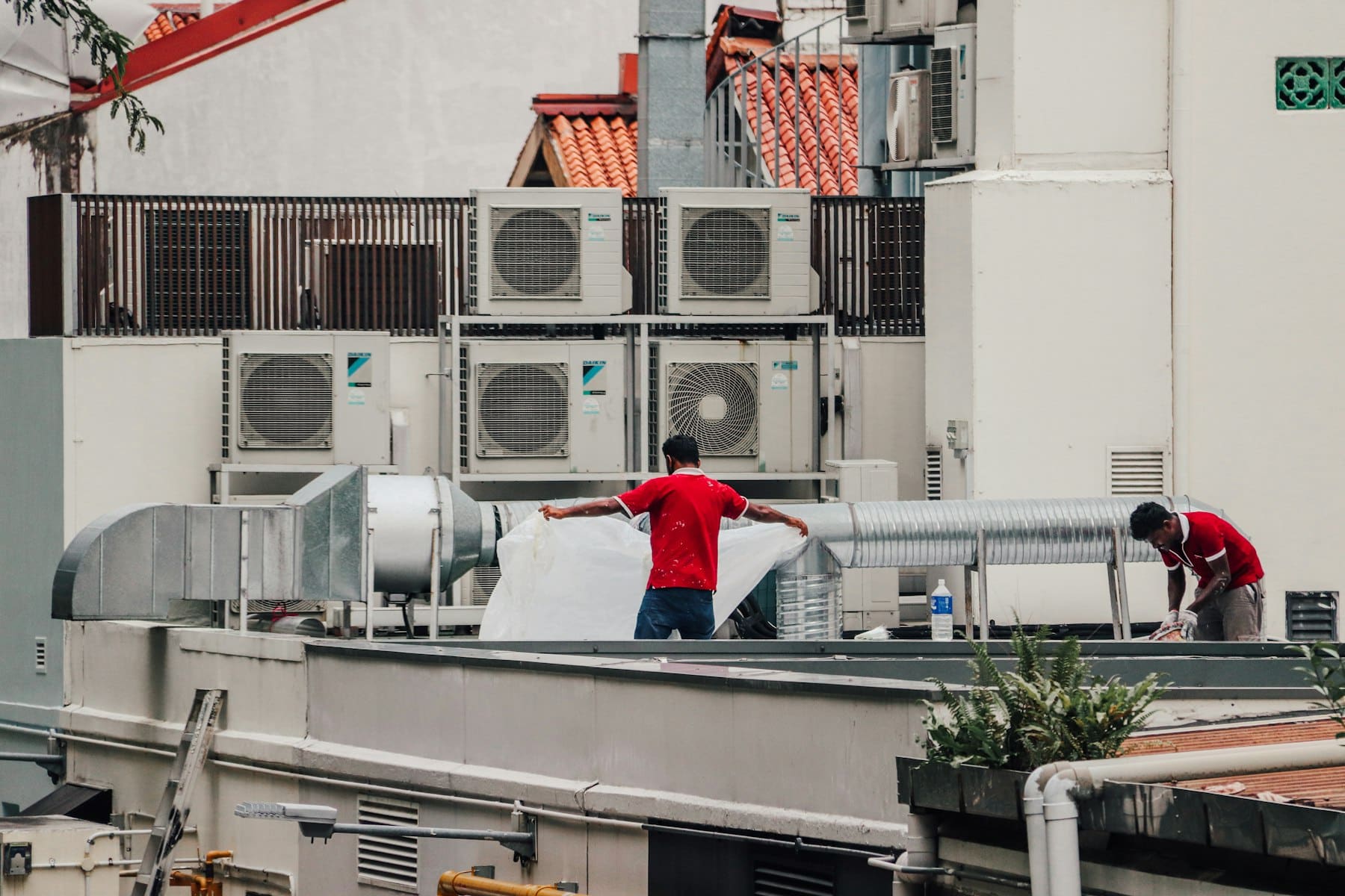 HVAC technician working on a rooftop unit