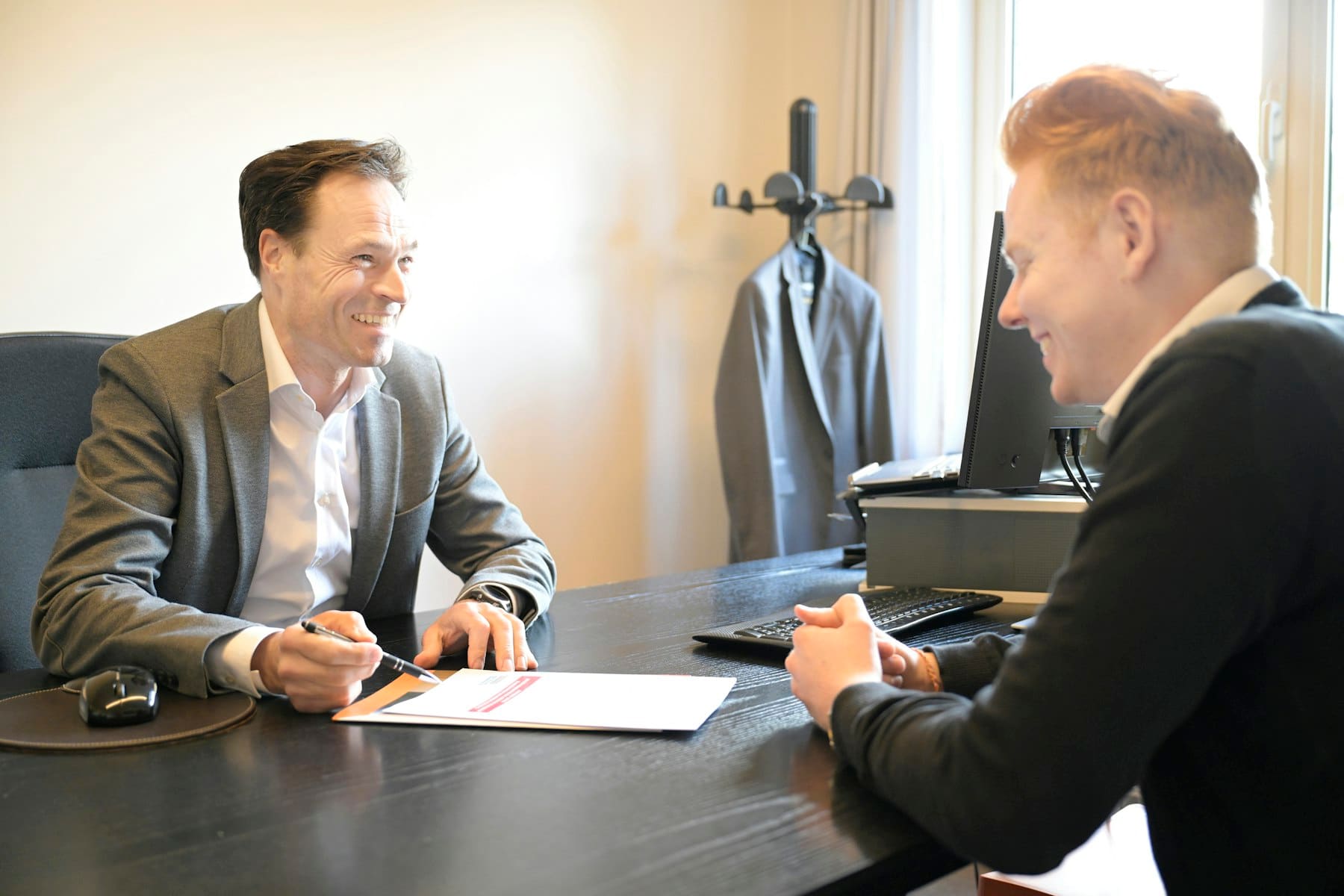 Two attorneys reviewing documents together in an office