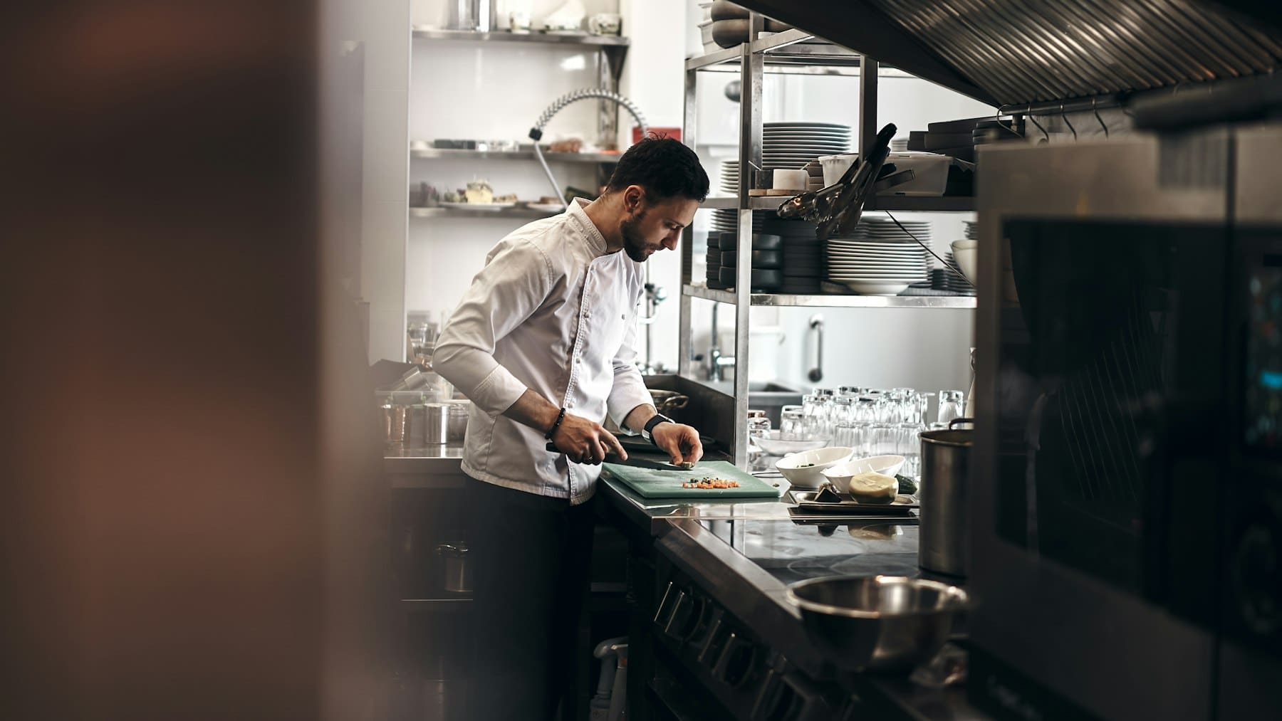 Chef preparing a dish in a restaurant kitchen